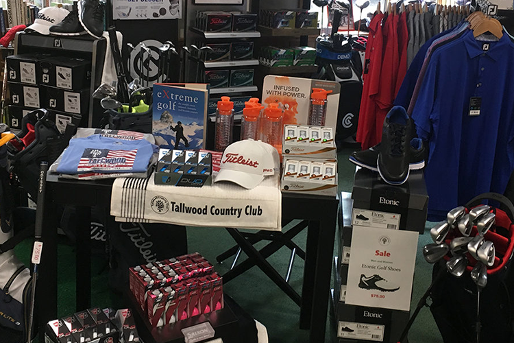 view of proshop merchandise including water bottles, golf clubs, apparel, and shoes